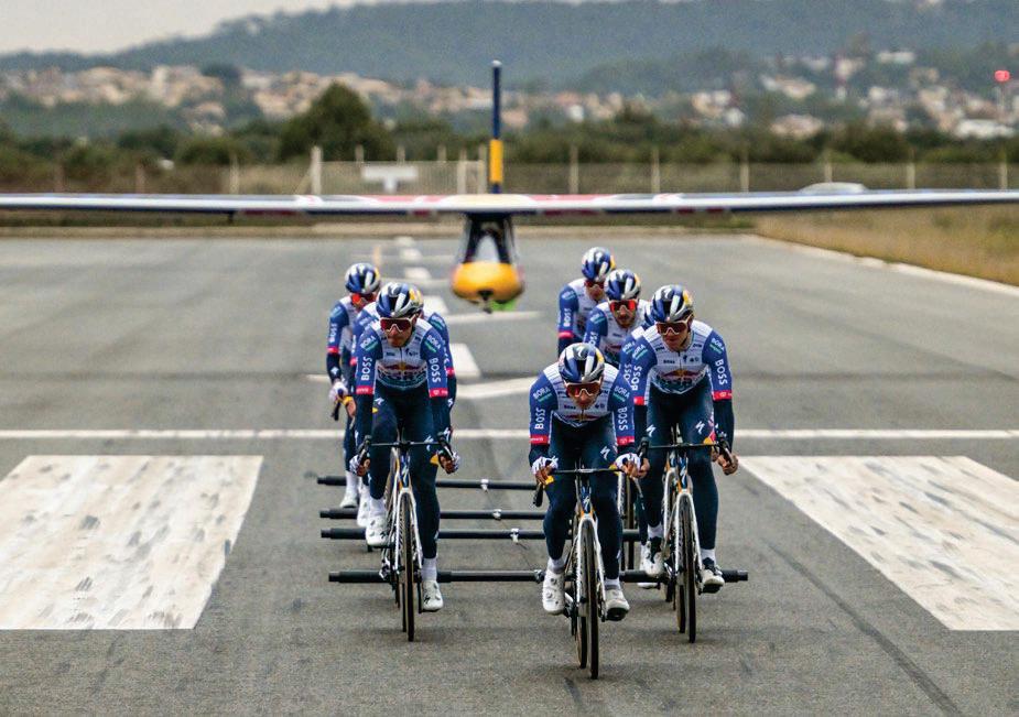 Nine Red Bull-Bora-hansgrohe riders tow a glider to take-off