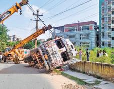 Overturned truck crushes woman