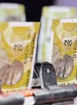 Rupee slides to record low on global jitters, outlook fragile