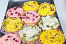 Hands full of mehendi, plates full of ghewar