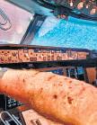 { PILOT INJURED } PLANE WITH 140 PASSENGERS DIVERTED Space debris shatters Boeing windshield mid-air