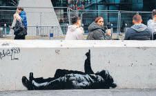 Street artist Banksy unveils latest work in UK