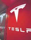 Profits fall, but Tesla’s shares keep rising on AI hopes