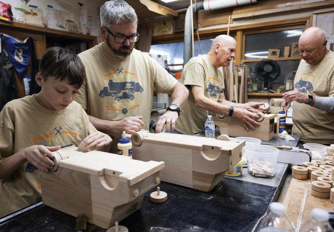 Volunteers use donated wood to craft gifts for kids