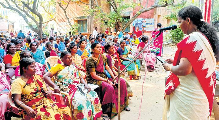 Female sanitary workers gather to discuss their workplace problems