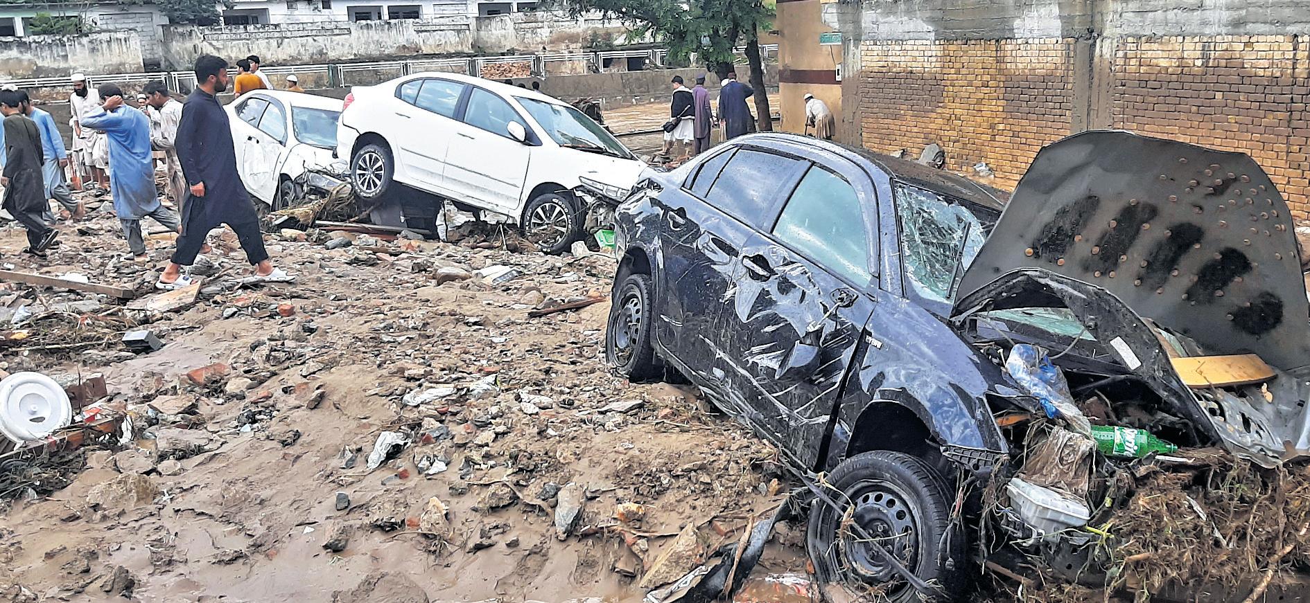 Pakistan rescuers recover bodies after flash floods in monsoon rains kill over 340 people