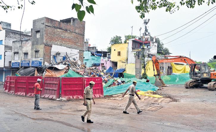 One dead as three-storey building crashes down