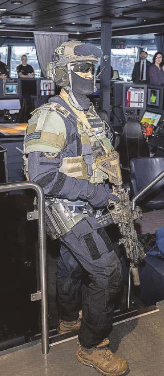Camo-clad men ready to confront dark ships