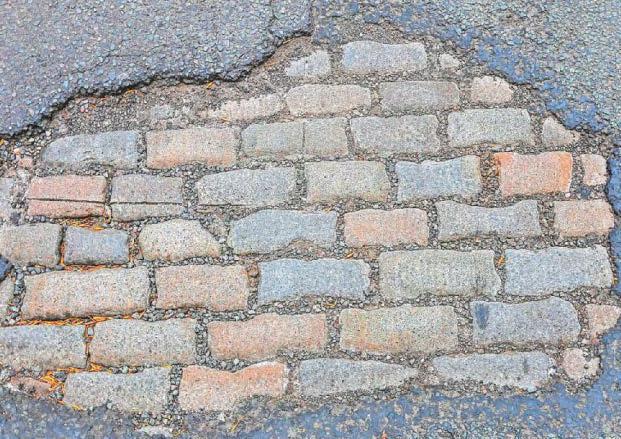 Stone me! Time warp Victorian cobbled street revealed under large pothole