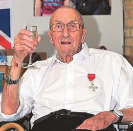 War hero Geoff wears his new MBE medal on 100th birthday
