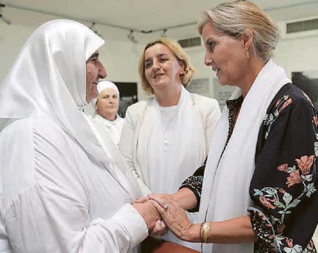 Sophie comforts mother of genocide massacre victim