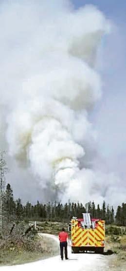 Major wildfire rages as mercury hits 34C