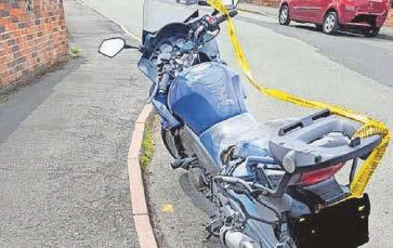 Biker in the hot seat ... vehicle on fire as it passes police