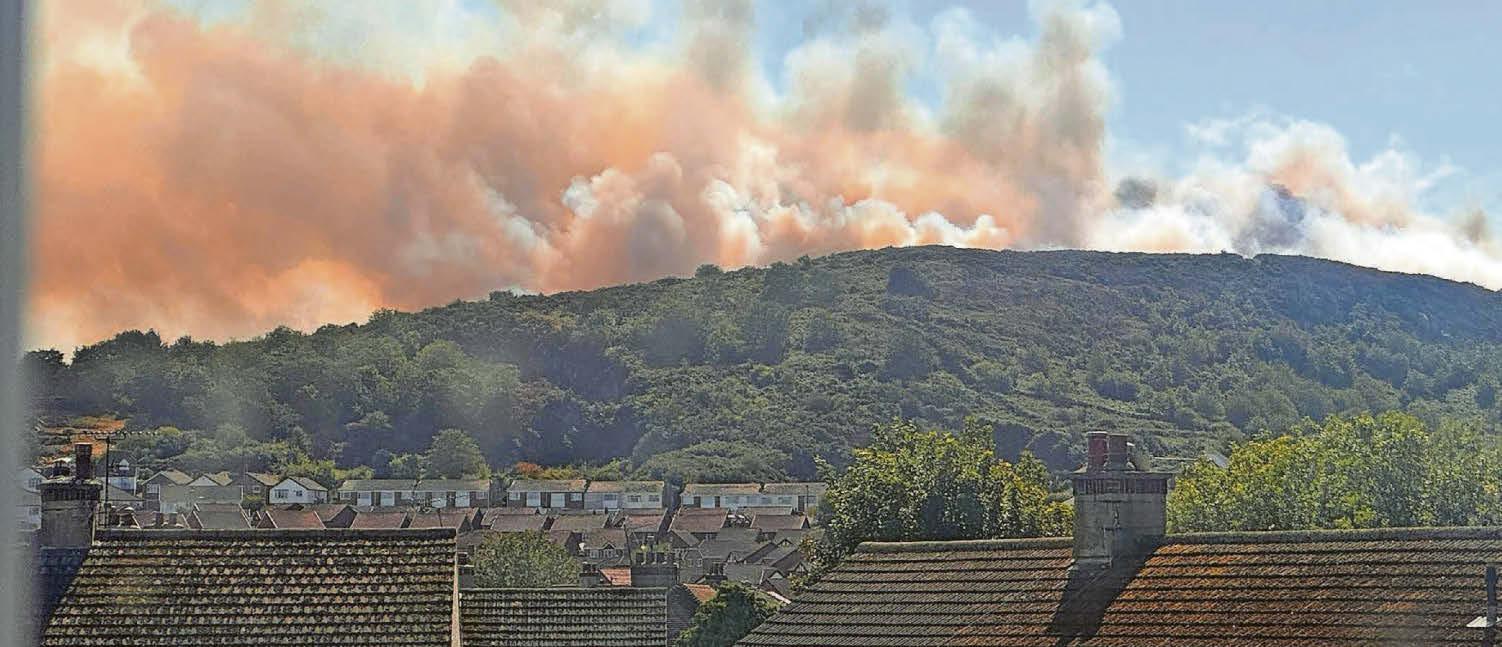 SMOKE FROM HILLSIDE BLAZE DRIFTS OVER TOWN