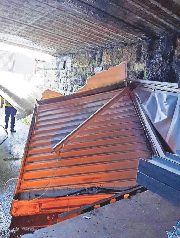 ROAD CLOSED AFTER LORRY STRIKES LOW BRIDGE