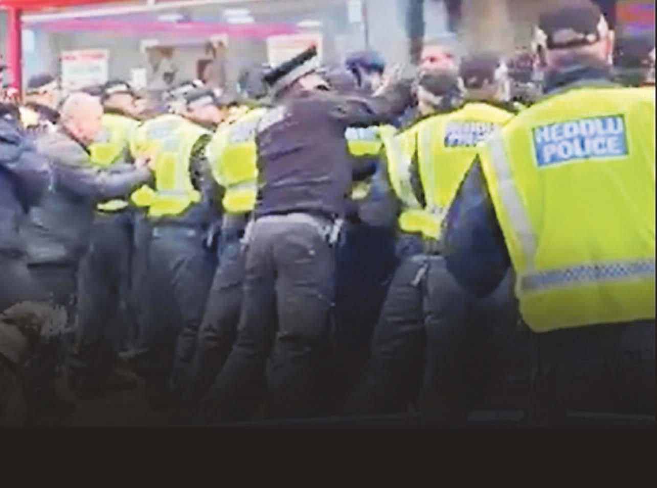 Police defend 'use of force' as 'jab towards fans' caught on camera