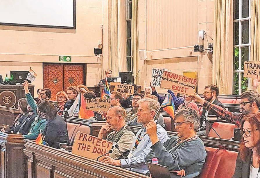 Trans rights Councillors wave flags and placards at gender critical activists
