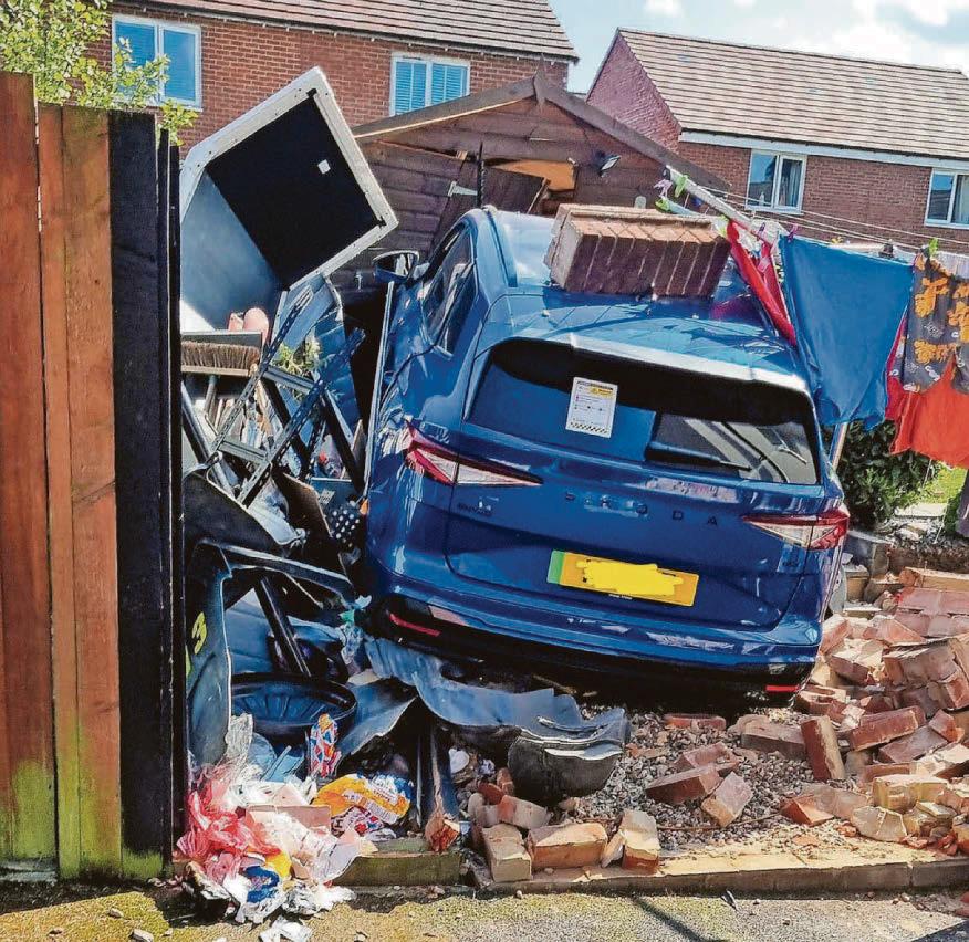 No one hurt as car crashes through wall into shed