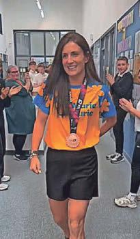 School's cheers for marathon teacher