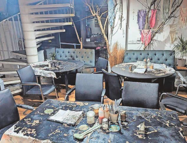 Café 'rises from the flames' after firebomb attack