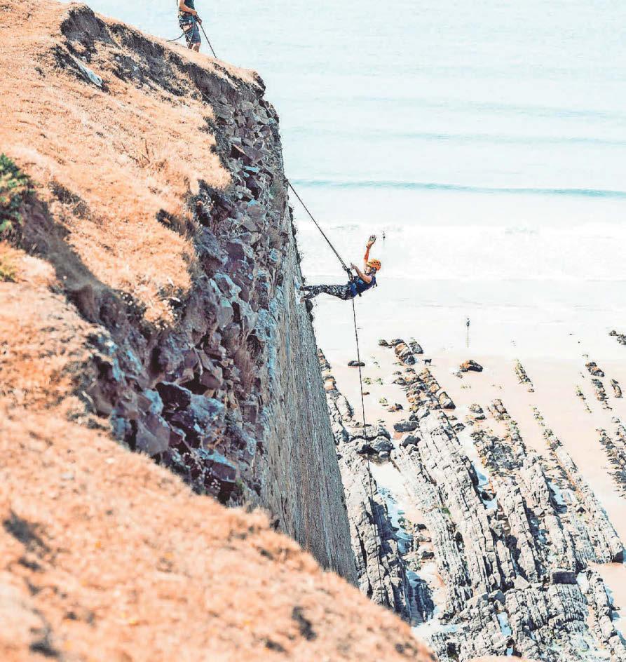 Nurses and supporters take on giant cliff face abseil