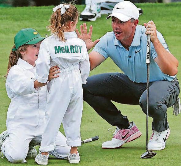 Poppy, 4, shows dad Rory how it's done at Augusta!