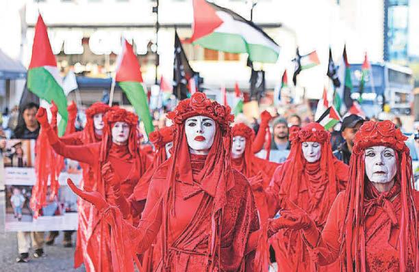 The Red Rebel Brigade lead a silent 'funeral procession'