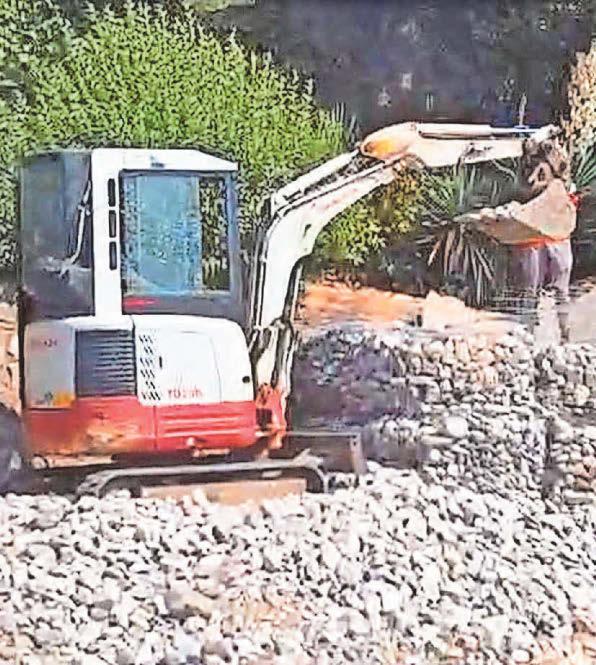 Police attend beach as digger scoops up stones