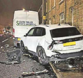 Two hurt after car ploughs into parked vehicles