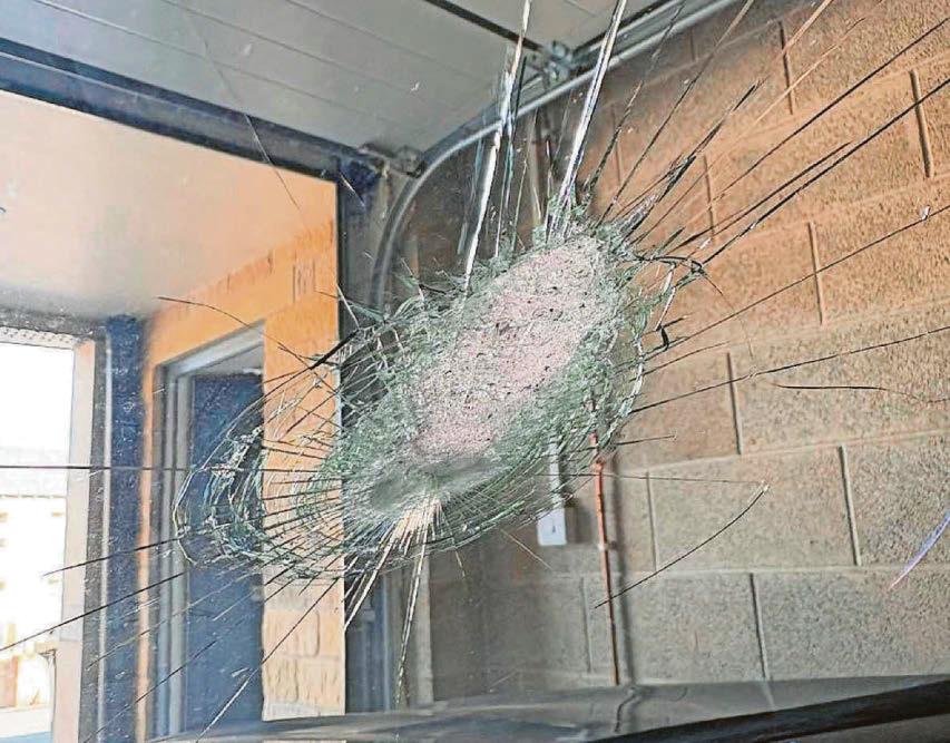 Kids showered with glass as stone dropped onto car