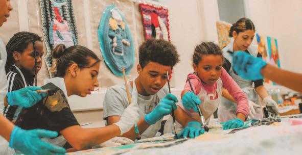 Young people celebrating global cultures with giant tapestry