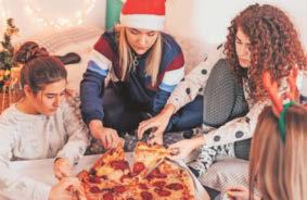Young adults going crackers for a slice of Yuletide pizza!
