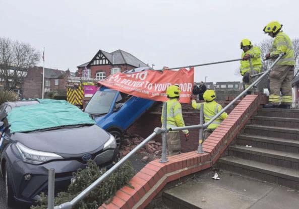 Chaos as car goes through wall and hits vehicle