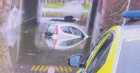 Cars trapped in floodwaters after heavy rain