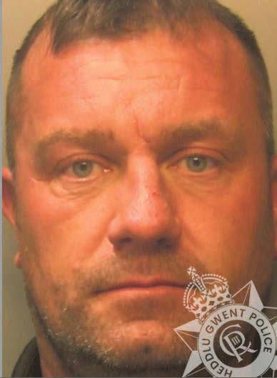 Thug clutched knives as he lay under duvet in wait for his partner