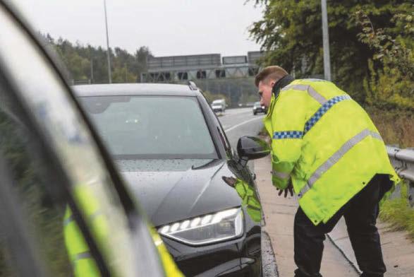 Driver was steering with knees on M1 while rolling a cigarette