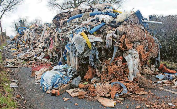 Charges over mountain of industrial waste left on road