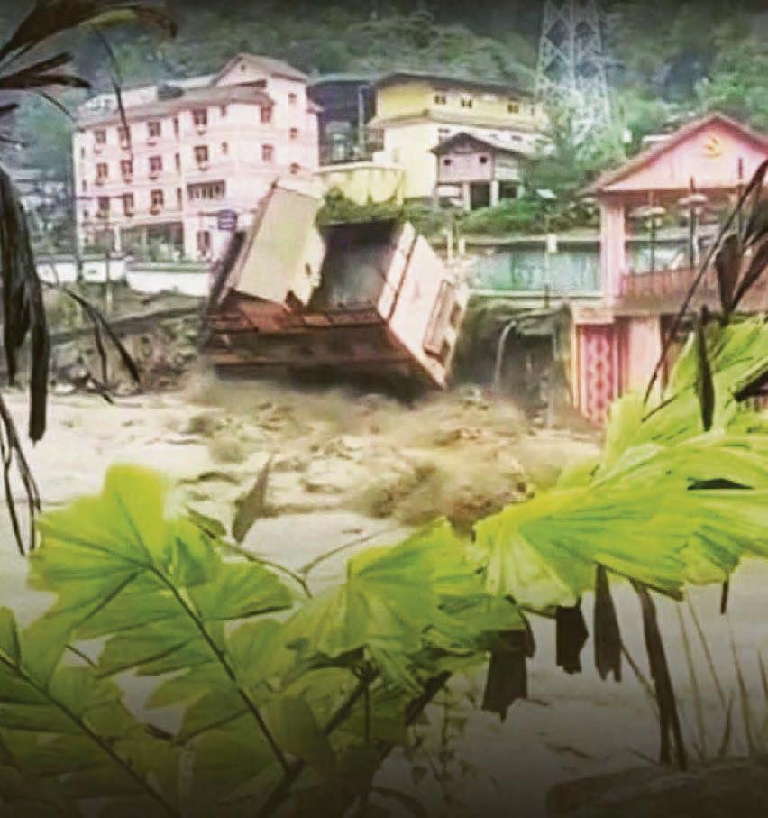 Hotel topples into river