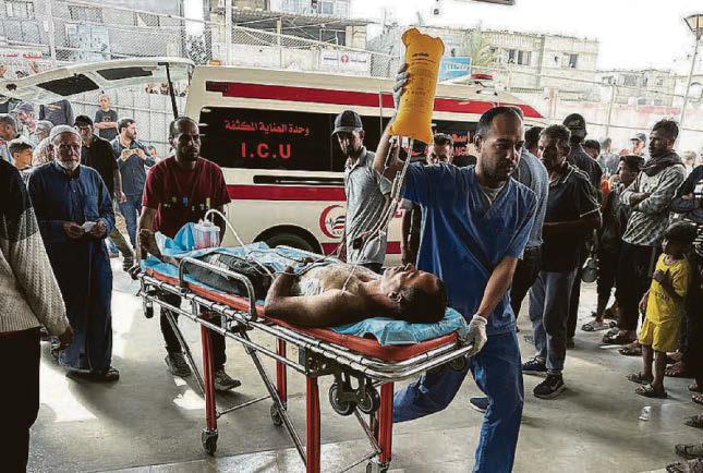 AT least 27 Palestinians were killed and dozens injured by Israeli gunfire near an aid distribution point.