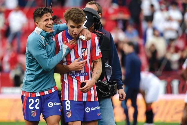 Barrios grabs Atletico late Liga victory at Sevilla