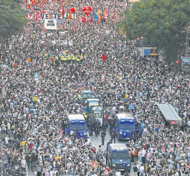 Tens of thousands protest on anniversary of deadly flood