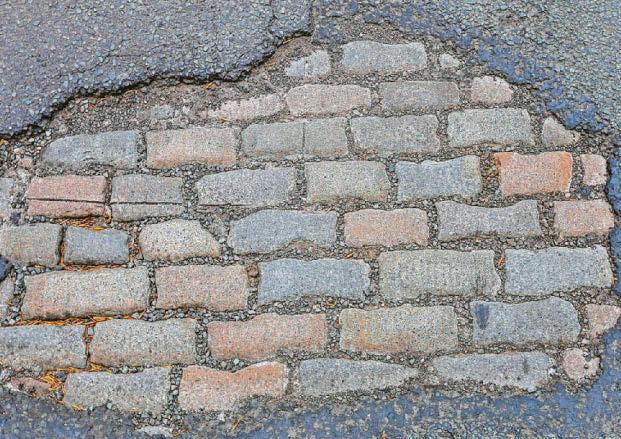 Stone me! Time warp Victorian cobbled street revealed under large pothole