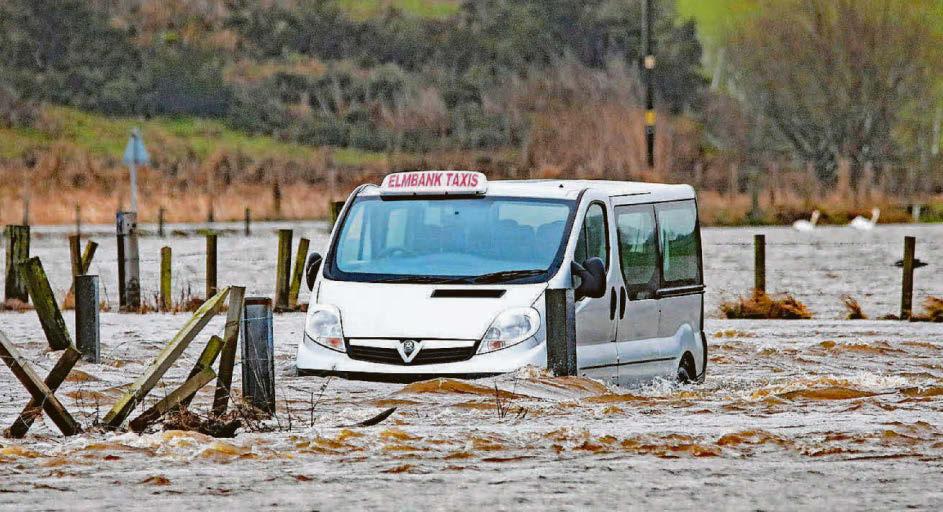 Two rescued from marooned taxi as floods cause chaos