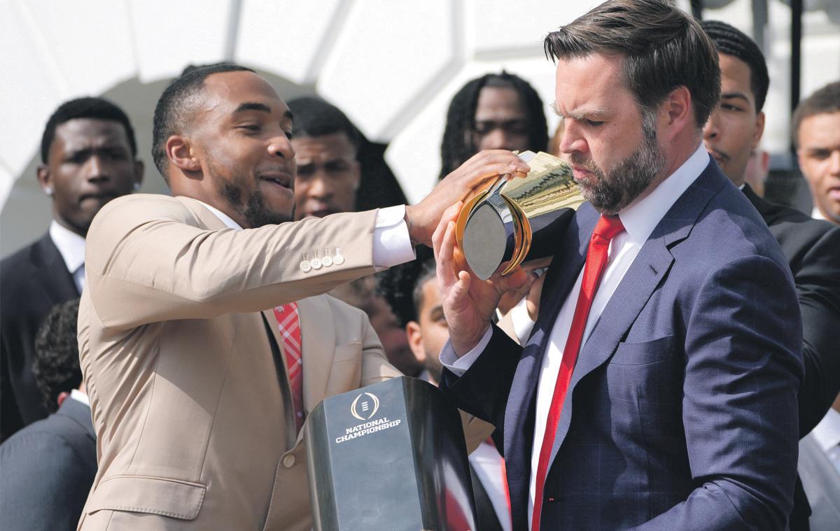 Safe pair of hands? Vance drops visiting university team's trophy