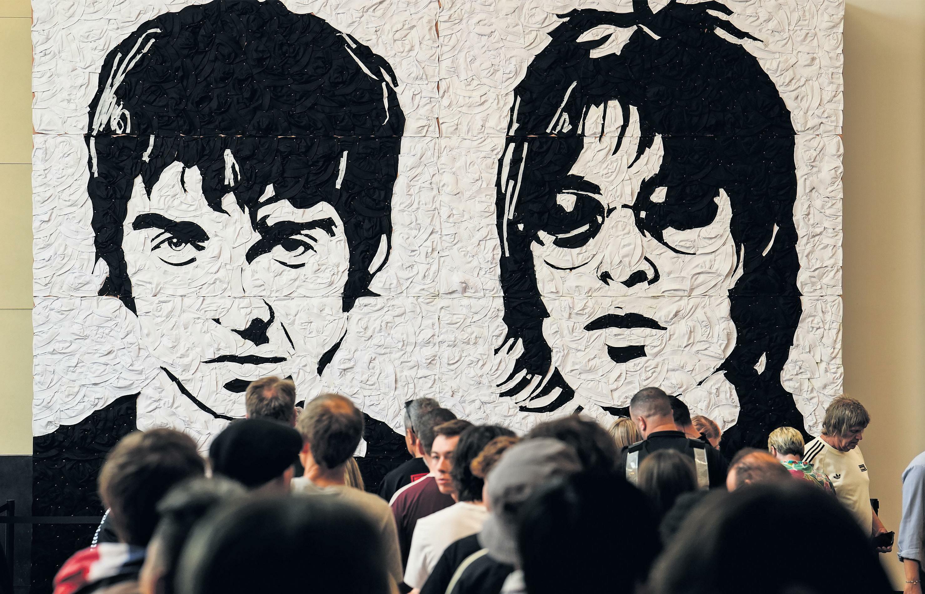 One for the bucket hat list: fans flock to Cardiff for first Oasis concert in 16 years