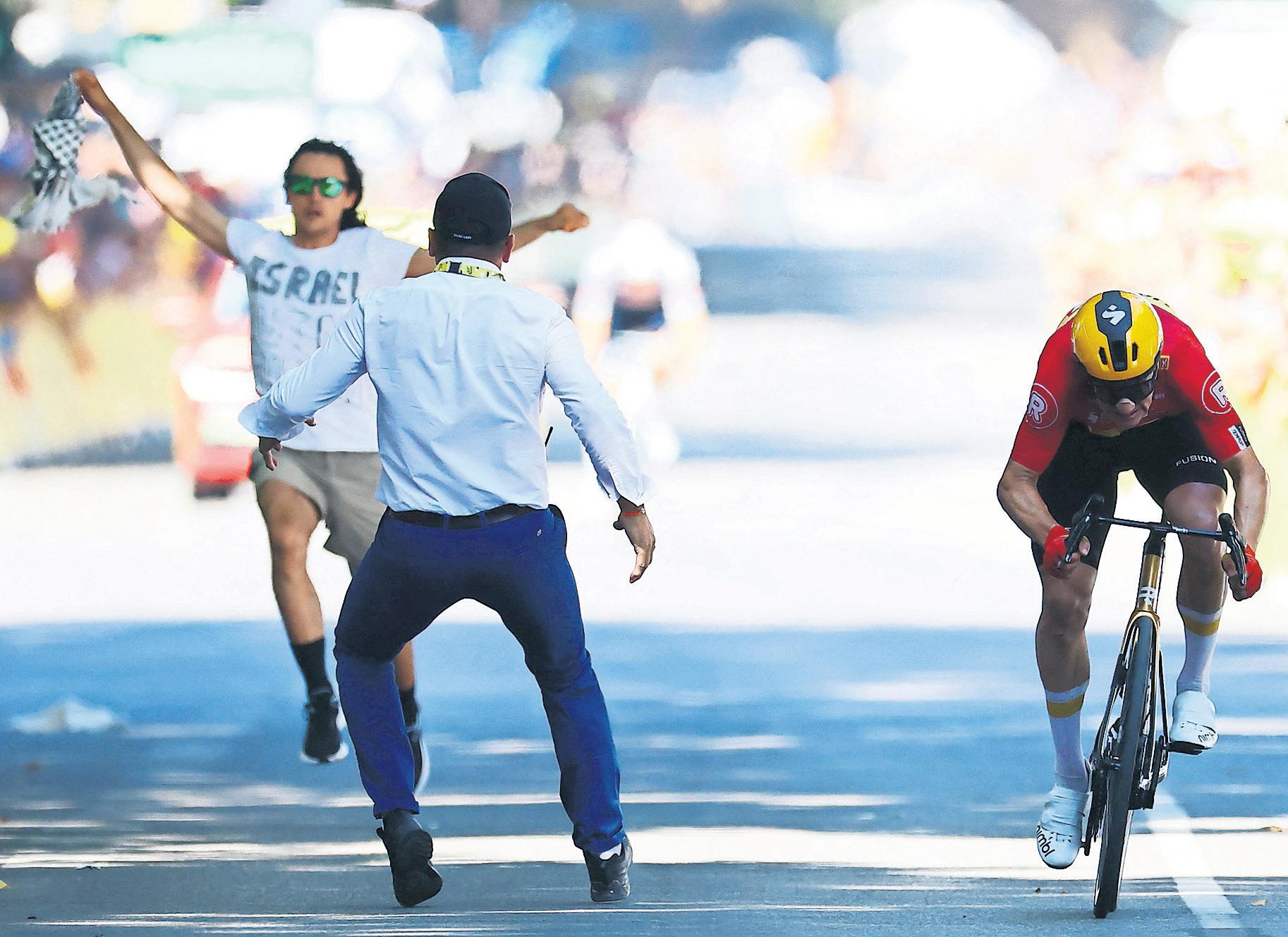Pogacar crashes and protester runs on road in chaotic climax