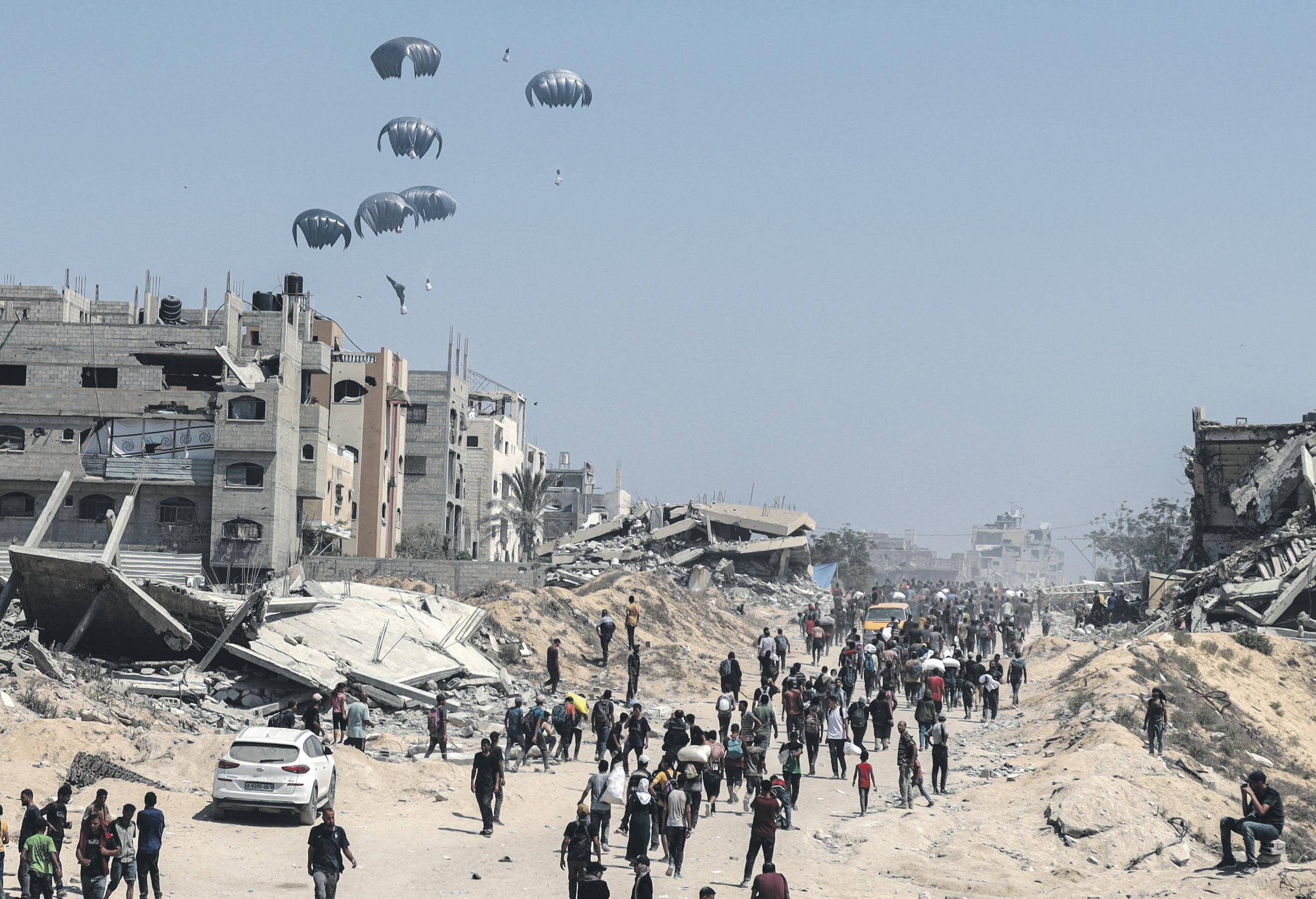 Palestinians wary as Israel begins limited pauses to let aid into Gaza