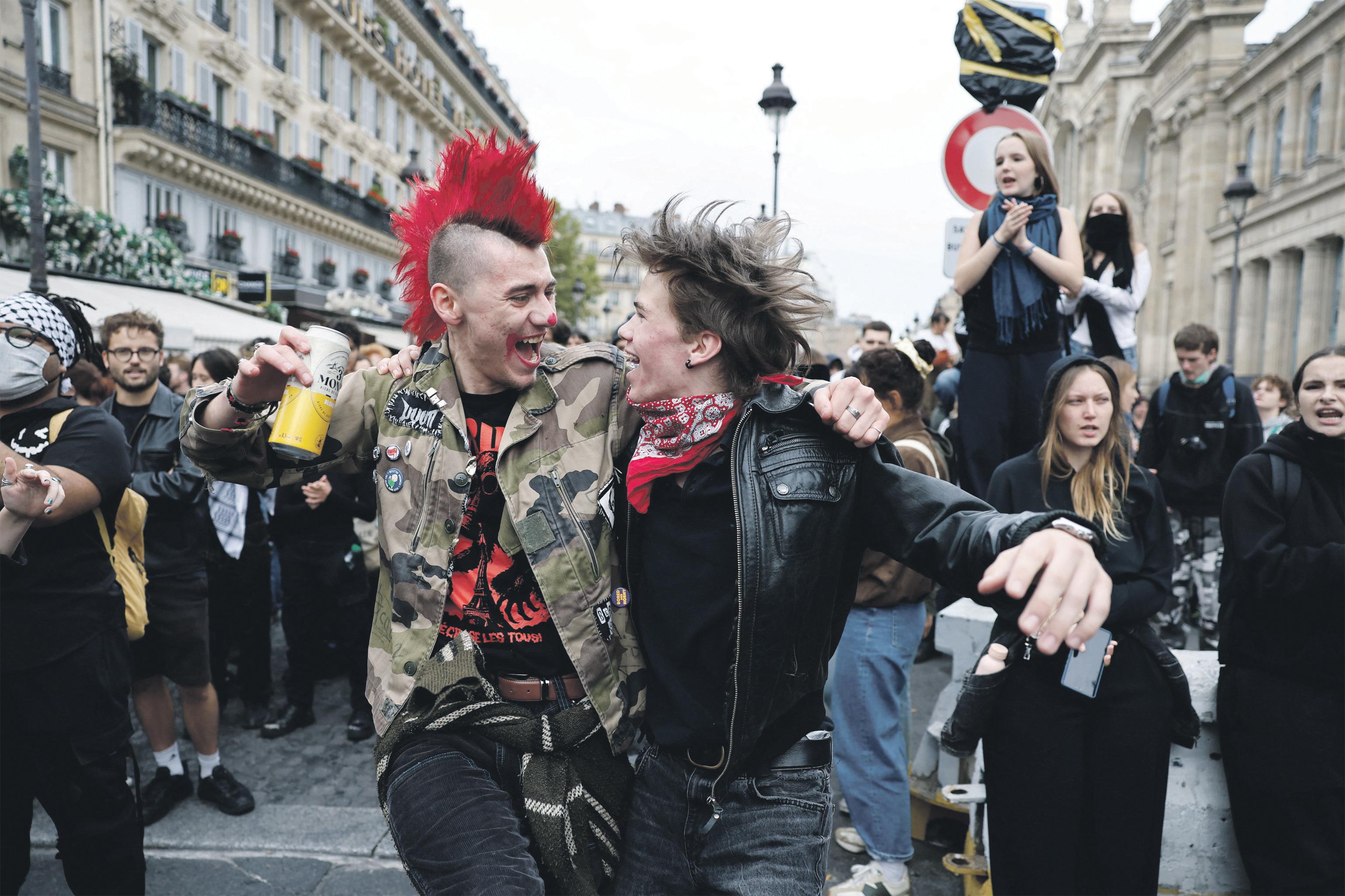 New French PM pledges 'humility' as thousands take to the streets