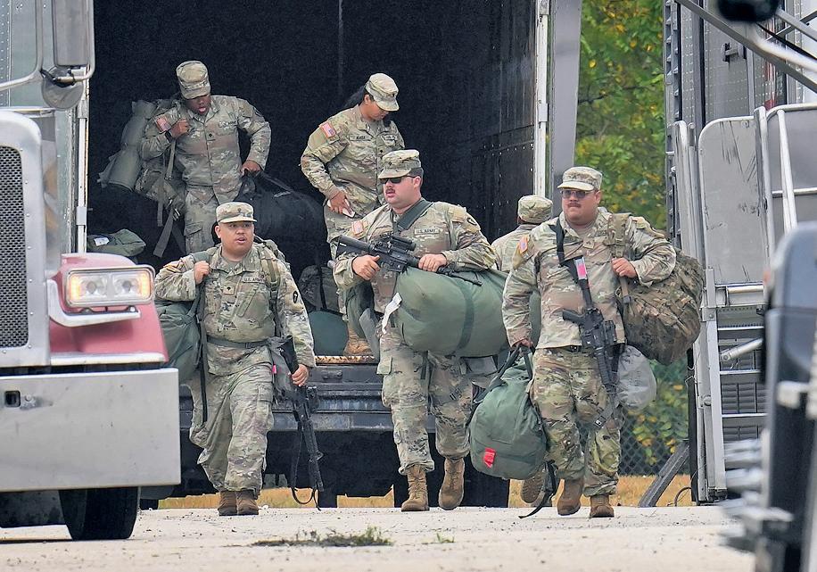 Trump calls for elected officials to be jailed as troops arrive in Chicago