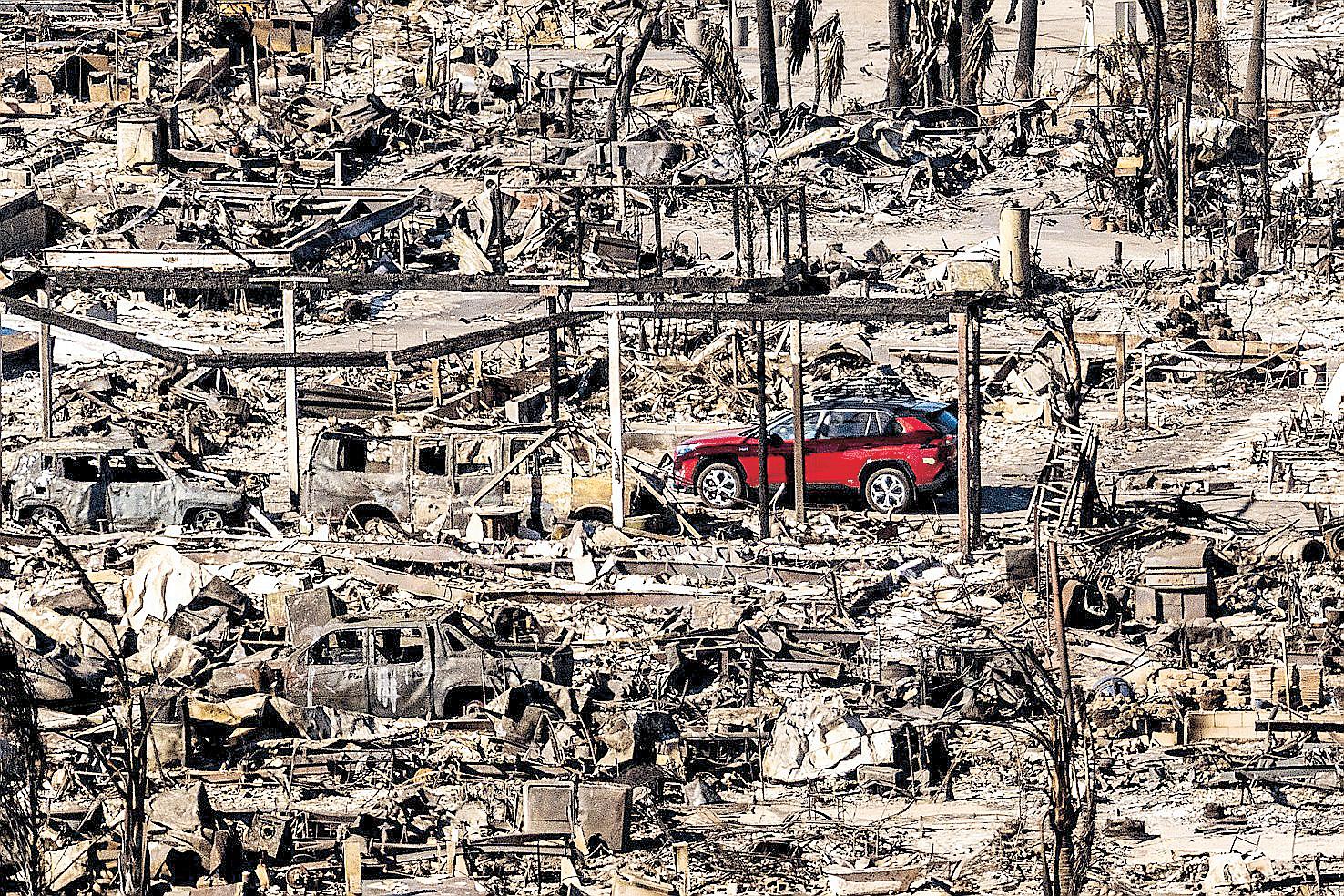 LA races to contain wildfires before winds return